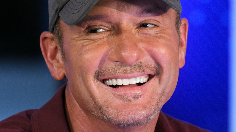 Tim McGraw smiling in baseball cap