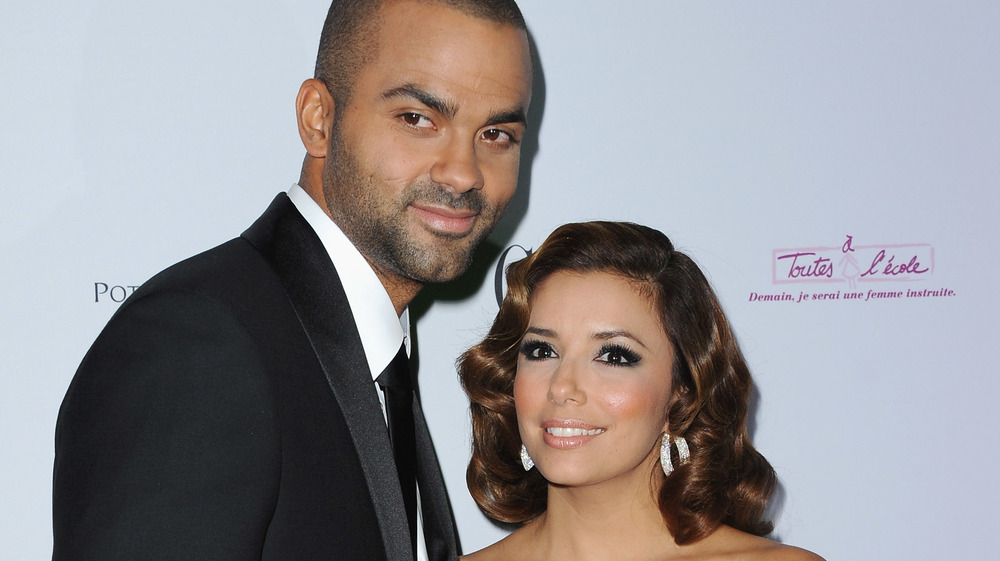 Tony Parker and Eva Longoria smiling on the red carpet