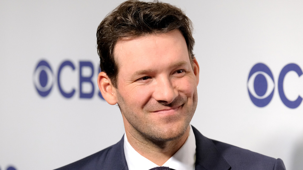 Tony Romo smiling before commentating a game on CBS