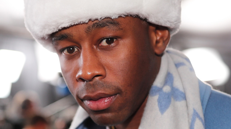 Tyler The Creator wearing an LV scarf