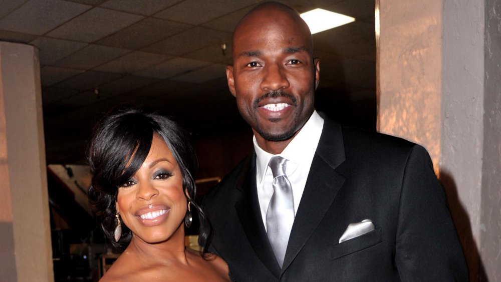 Niecy Nash, Jay Tucker smiling together at an event
