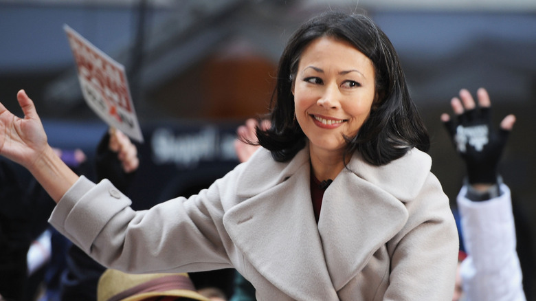 Ann Curry smiling and putting her arm out to her side