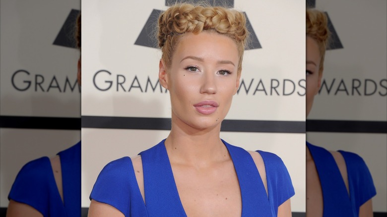 Dressed in a blue number and sporting a braided crown, Iggy Azalea stares into the camera.