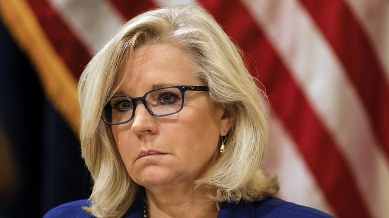 Liz Cheney looking stern in close-up black rim glasses