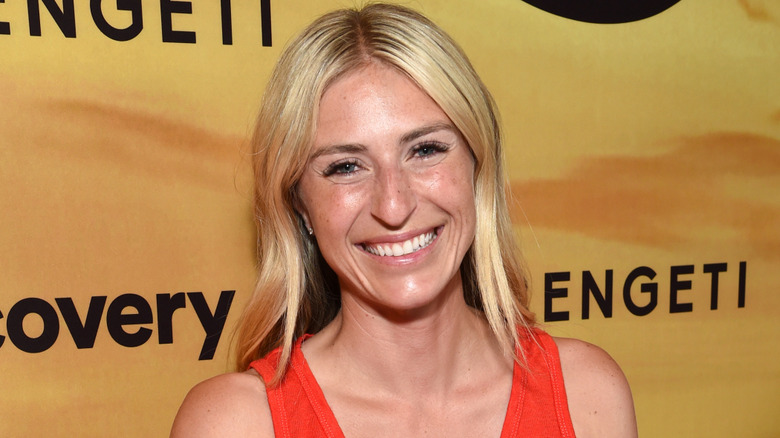 Jasmine Roth smiling while wearing an orange top