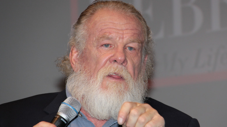 Nick Nolte speaking into microphone