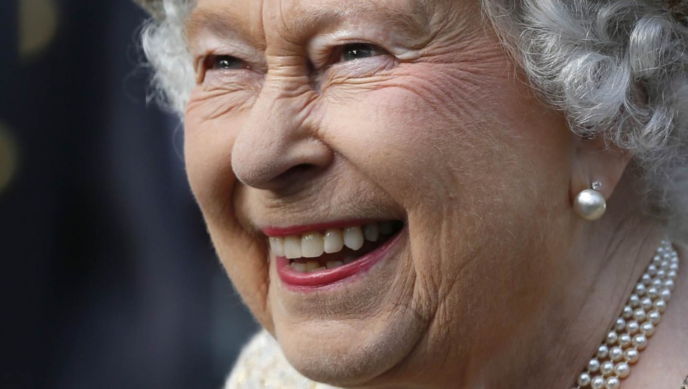 The Real Story Behind A Viral Photo Of Queen Elizabeth Laughing Next To A Uniformed Prince Philip