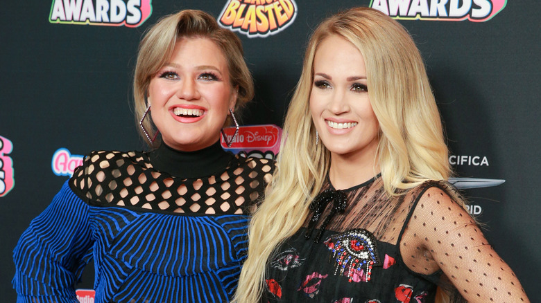 Kelly Clarkson and Carrie Underwood smiling