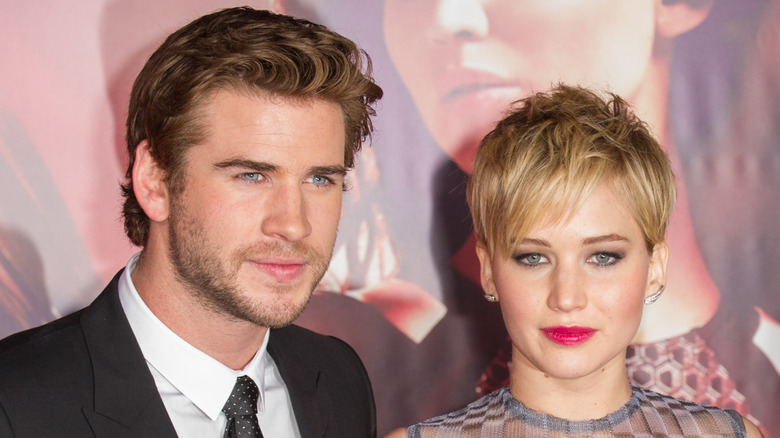 Liam Hemsworth posing with Jennifer Lawrence