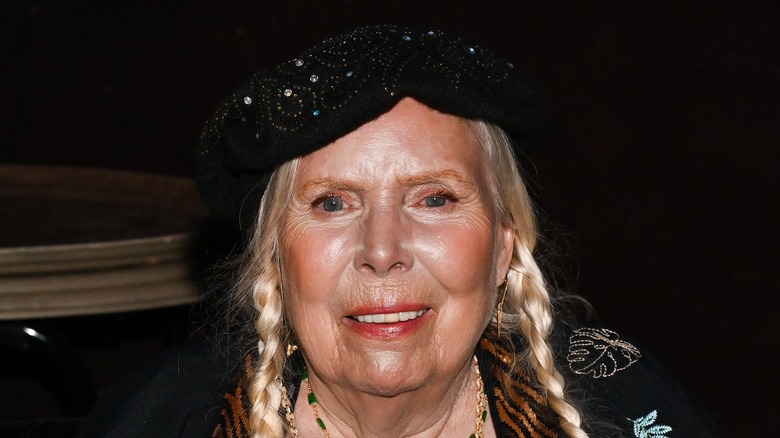 Joni Mitchell wearing black beret in close-up