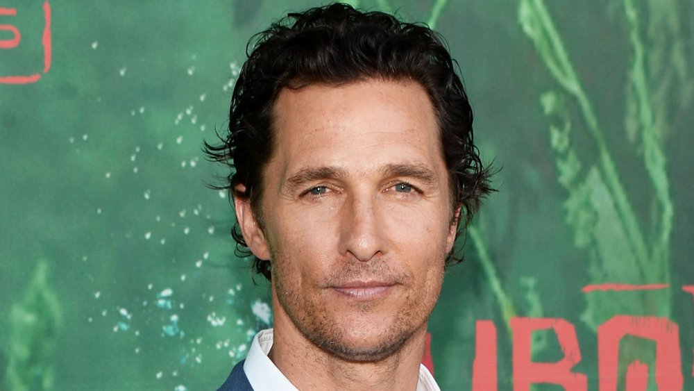 Matthew McConaughey in front of green promo wall