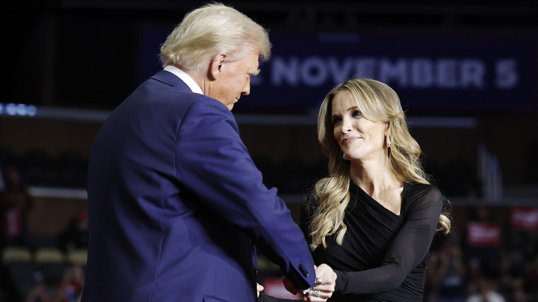 Megyn Kelly shaking hands with Donald Trump at a rally.