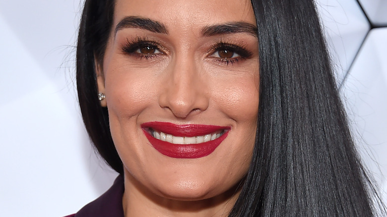 Nikki Bella smiles in red lipstick