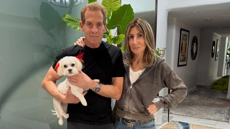 Skip Bayless and Ernestine Sclafani pose with their Maltese dog