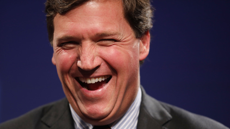 Tucker Carlson laughing