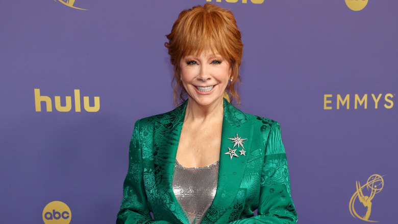 Reba McEntire wearing a green suit