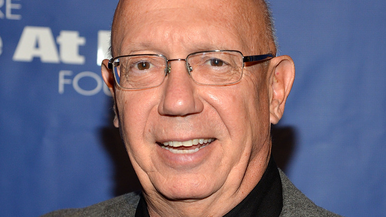 Dann Florek wearing glasses and smiling