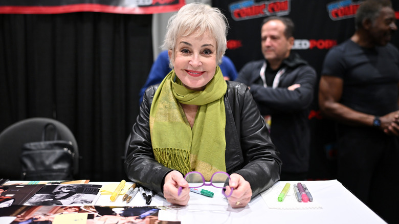 Annie Potts posing for pictures at a signing.