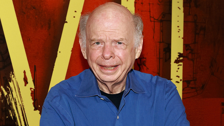 Wallace Shawn posing on the red carpet.