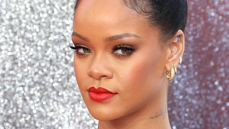 Rihanna wearing three hoop earrings