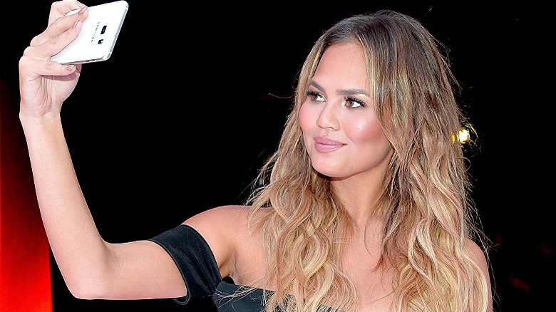 Chrissy Teigen snapping a selfie