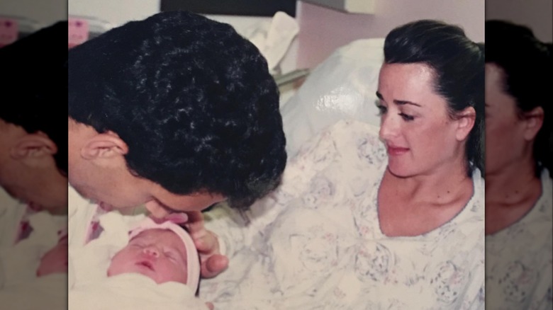 Kyle Richards and Mauricio Umansky holding their baby