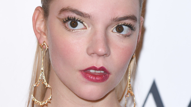 Anya Taylor-Joy on the red carpet with surprised expression