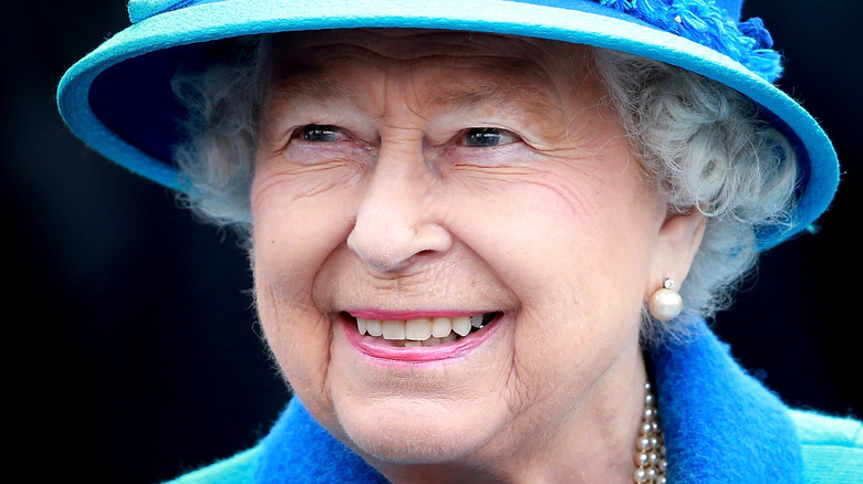 Queen Elizabeth smiling in blue