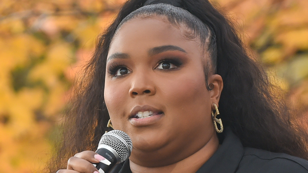 Lizzo speaking into mic