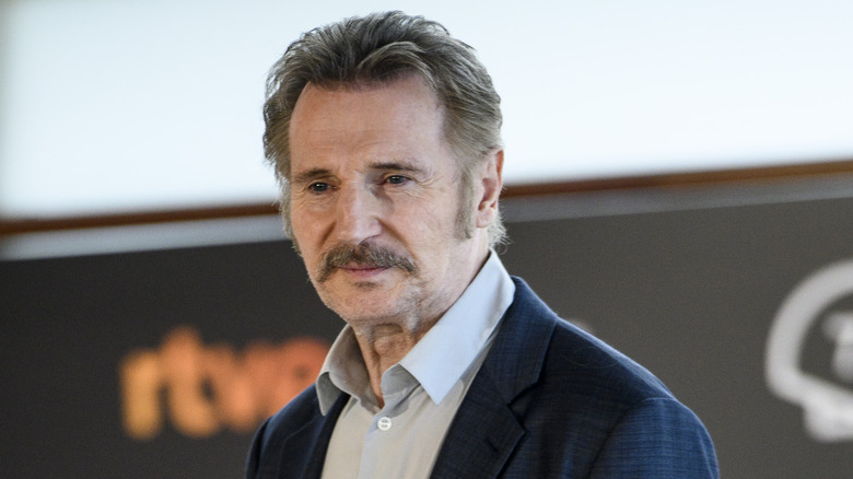 Liam Neeson smirking