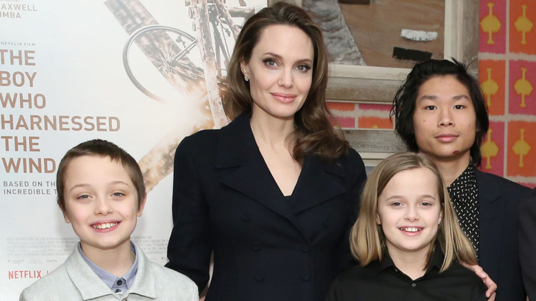Angelie Jolie posing with Knox, Vivienne and Pax Jolie-Pitt.