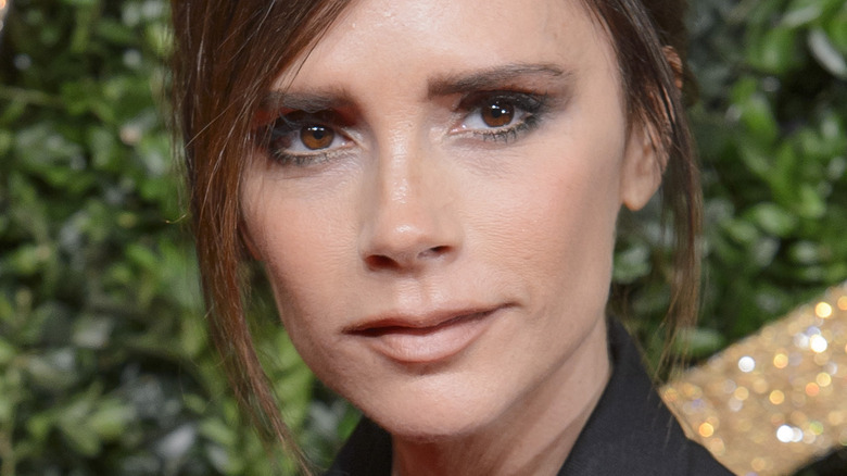 Victoria Beckham poses in a black suit