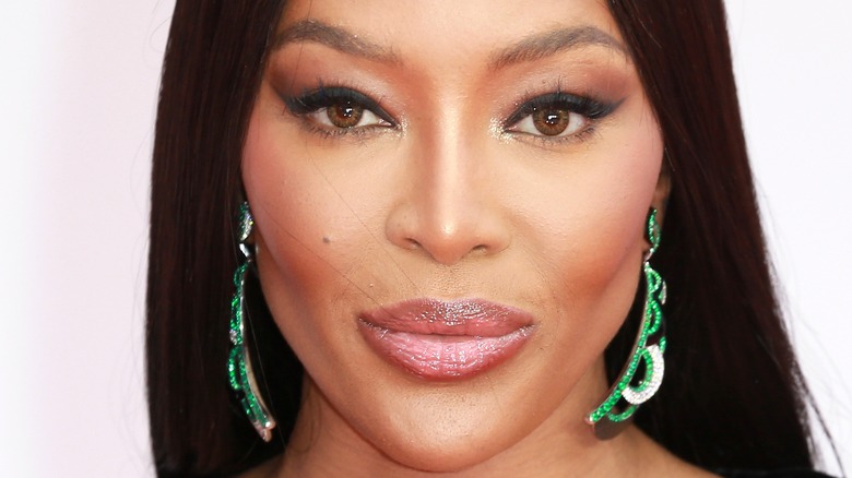 Naomi Campbell wears green earrings