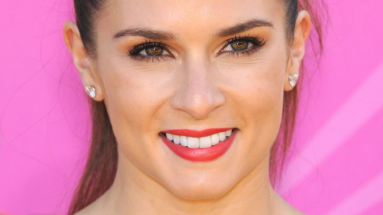 Danica Patrick smiles in red lipstick