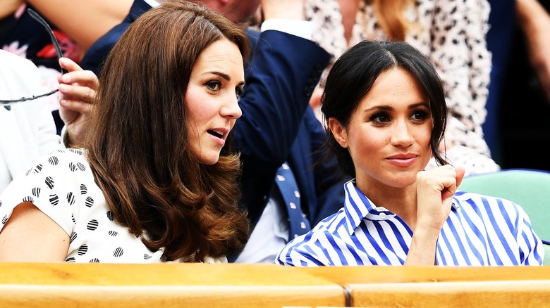 Meghan Markle and Kate Middleton speaking in audience