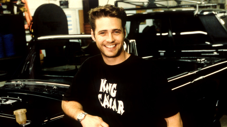 Jason Priestley posing in his garage, circa 1996