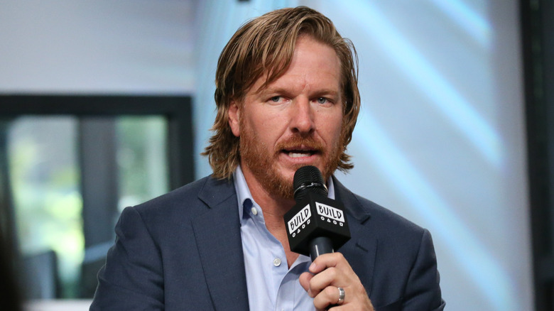Chip Gaines speaks into a mic in 2017