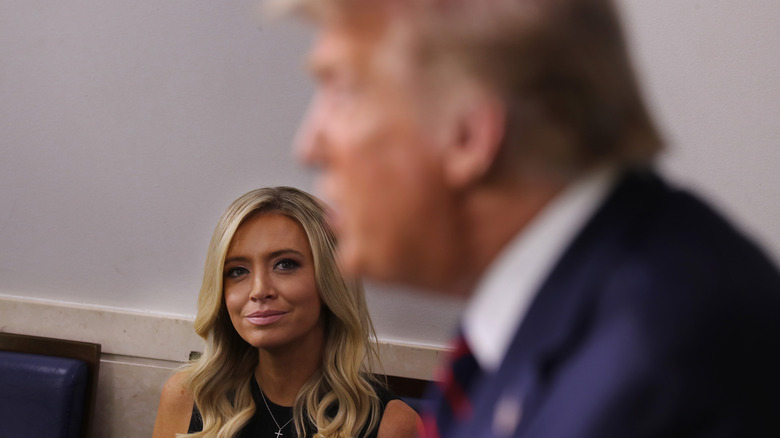 Kayleigh McEnany looks at Donald Trump as he speaks.