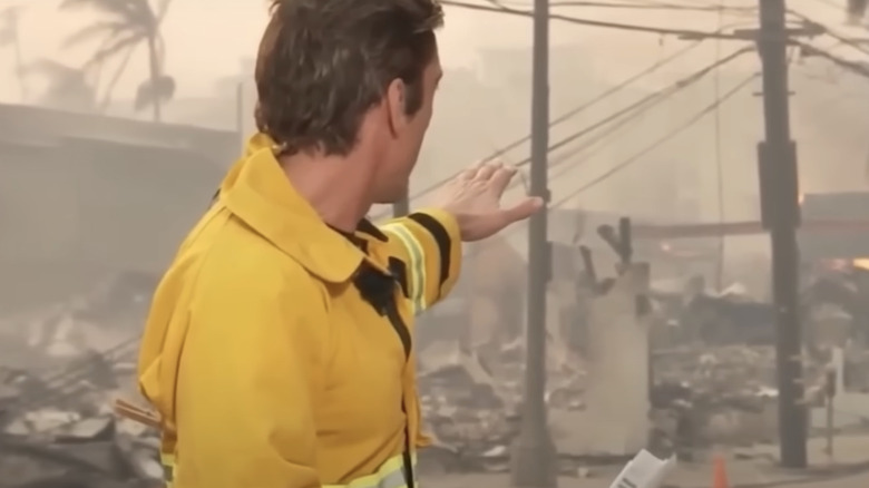 David Muir using clothespin to tighten flame-retardant jacket