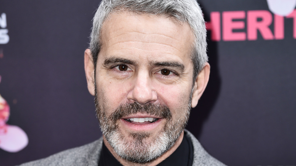 Andy Cohen smirking