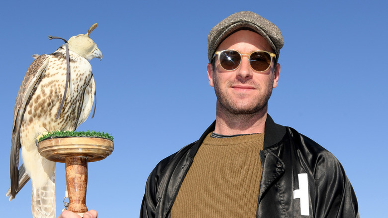 Armie Hammer holds a hawk in Saudi Arabia