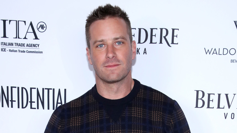 Armie Hammer shows a hint of a smile in LA