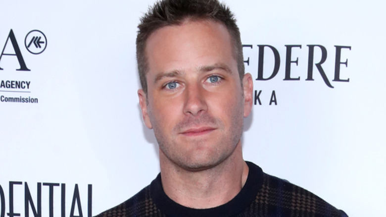 Armie Hammer shows a hint of a smile in LA