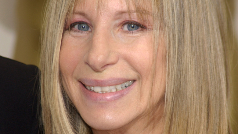 Barbra Streisand on red carpet, smiling