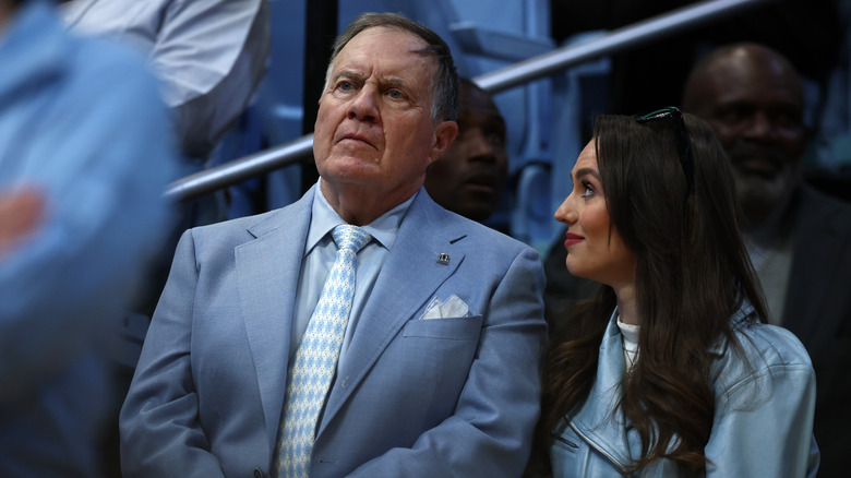 Bill Belichick with Jordon Hudson attending a football game
