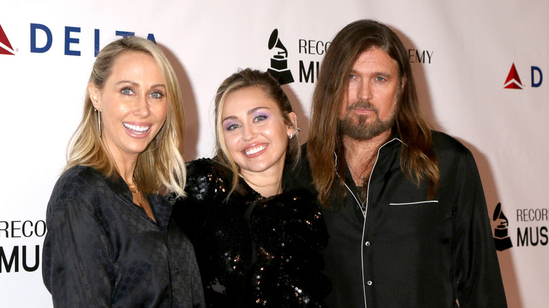 Billy Ray posing with Miley and Tish Cyrus