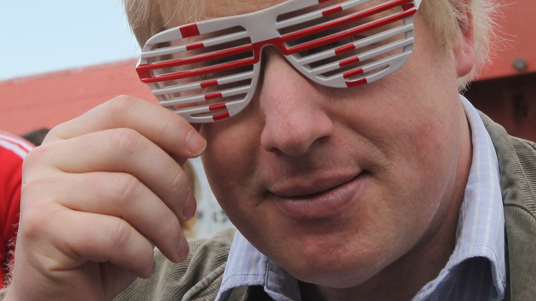 Younger Boris Johnson wearing England sunglasses
