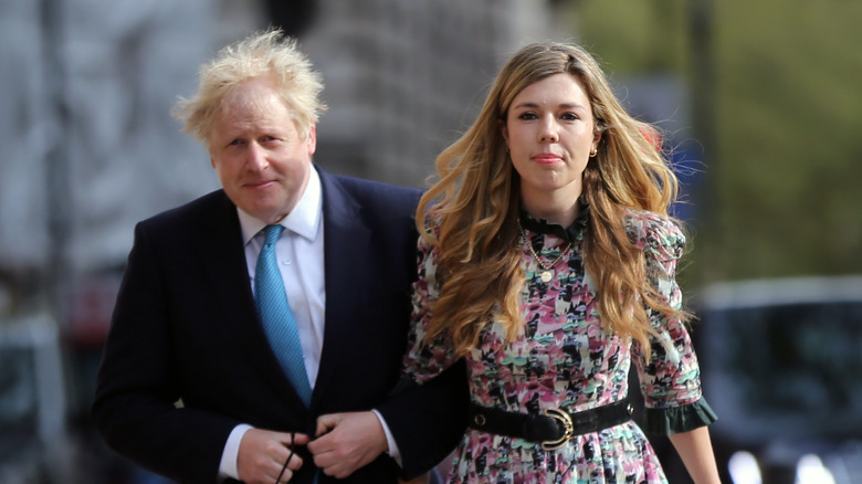 Boris Johnson and Carrie Symonds, walking outside