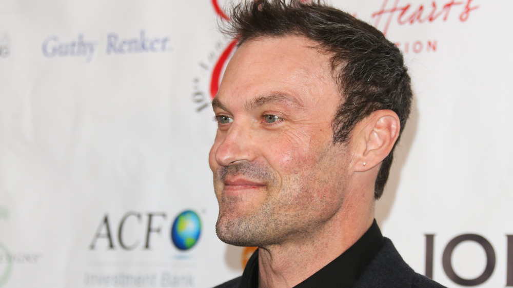 Brian Austin Green posing with a small smile at a charity event