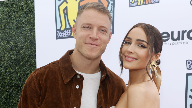 Christian McCaffrey and Olivia Culpo smiling